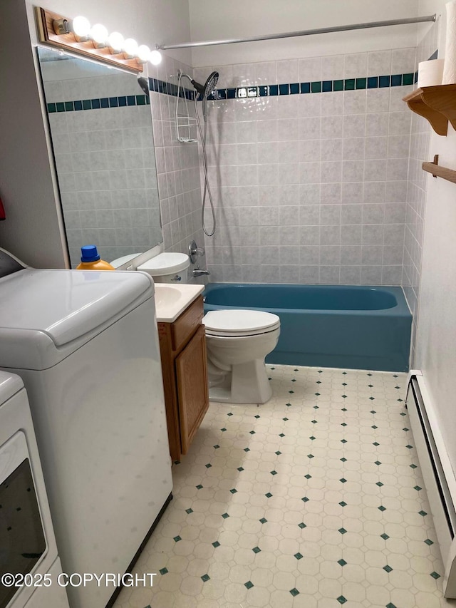 7700 E 32nd Ave, Anchorage, AK 99504 - full bathroom with washing machine and dryer, a baseboard heating unit, toilet, tile patterned floors, and vanity