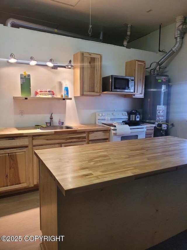7700 E 32nd Ave, Anchorage, AK 99504 - kitchen with butcher block counters, white range with electric stovetop, stainless steel microwave, a sink, and water heater