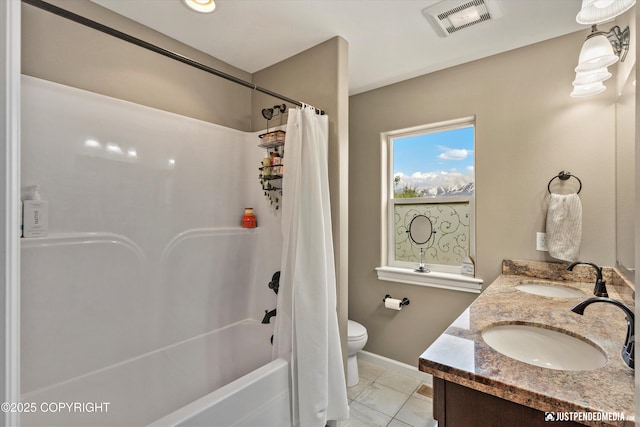 542 S Tender Arctic Dr, Palmer, AK 99645 - full bath featuring shower / bath combination with curtain, double vanity, baseboards, and toilet