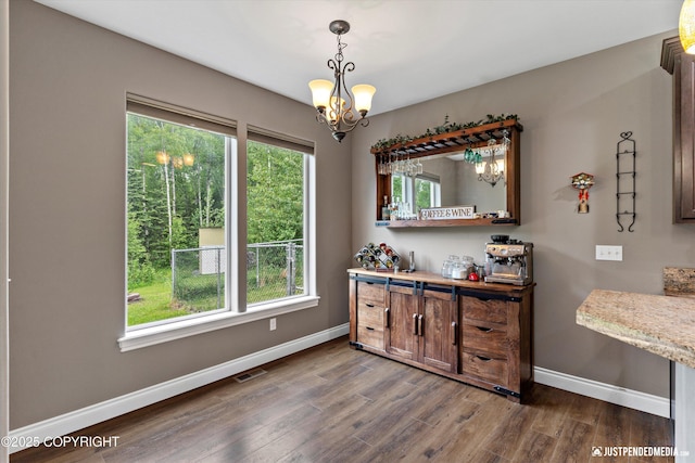 542 S Tender Arctic Dr, Palmer, AK 99645 - dining space with a chandelier, baseboards, and dark wood-type flooring