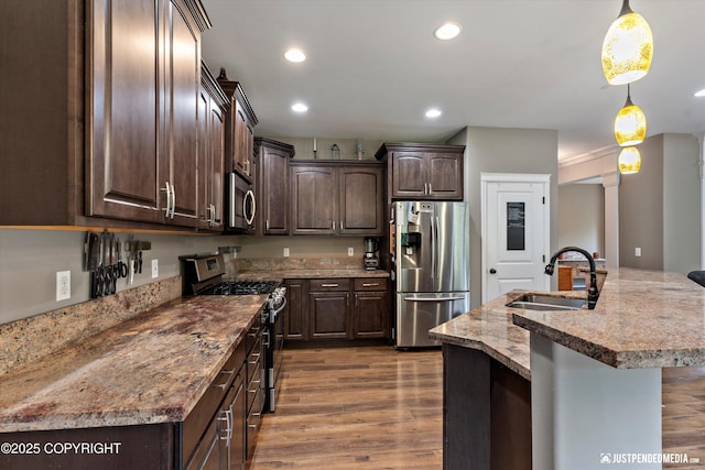 542 S Tender Arctic Dr, Palmer, AK 99645 - kitchen with stainless steel appliances, a sink, dark brown cabinets, dark wood-style floors, and recessed lighting