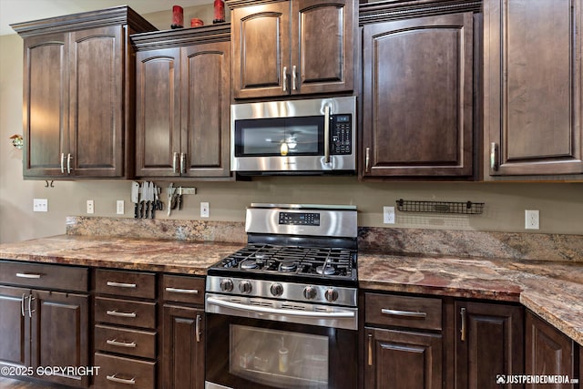 542 S Tender Arctic Dr, Palmer, AK 99645 - kitchen featuring stainless steel appliances, dark brown cabinets, and stone counters