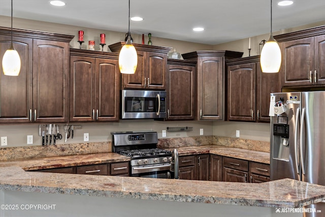 542 S Tender Arctic Dr, Palmer, AK 99645 - kitchen featuring appliances with stainless steel finishes, dark brown cabinetry, recessed lighting, light stone countertops, and pendant lighting