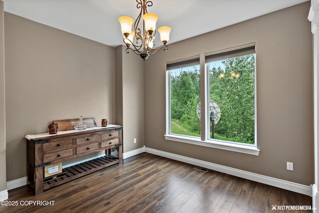 542 S Tender Arctic Dr, Palmer, AK 99645 - empty room with baseboards, a chandelier, and wood finished floors