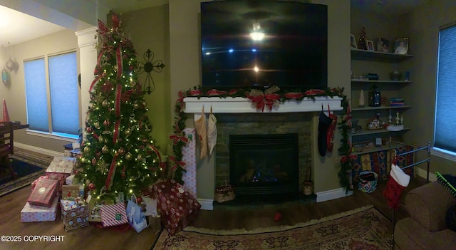 542 S Tender Arctic Dr, Palmer, AK 99645 - living area with wood finished floors, baseboards, and a stone fireplace
