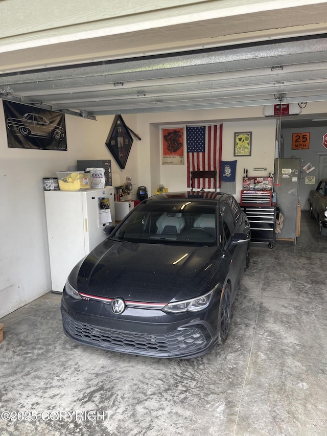 542 S Tender Arctic Dr, Palmer, AK 99645 - garage with freestanding refrigerator and a garage door opener