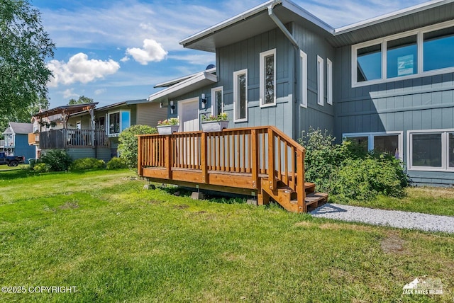 2105 W 47th Ave, Anchorage, AK 99517 - rear view of property with a wooden deck and a lawn