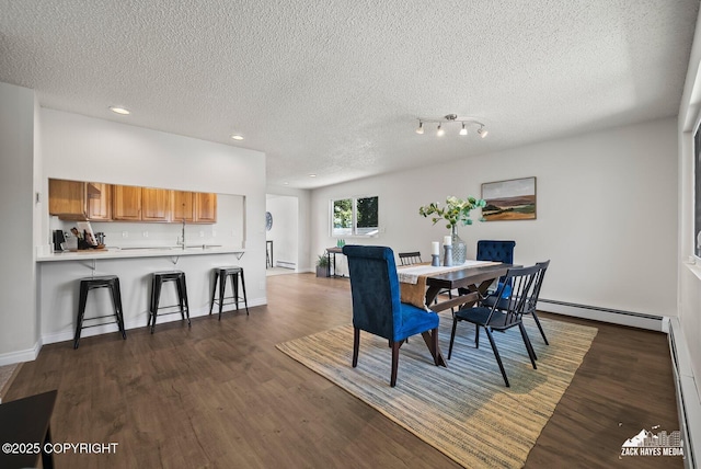 2105 W 47th Ave, Anchorage, AK 99517 - dining area featuring a baseboard radiator, a textured ceiling, dark wood finished floors, and recessed lighting