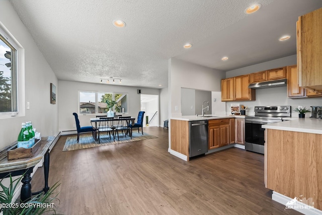 2105 W 47th Ave, Anchorage, AK 99517 - kitchen featuring stainless steel range with electric stovetop, dishwasher, under cabinet range hood, a textured ceiling, and light countertops
