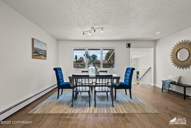2105 W 47th Ave, Anchorage, AK 99517 - dining room featuring baseboard heating, a textured ceiling, wood finished floors, and recessed lighting