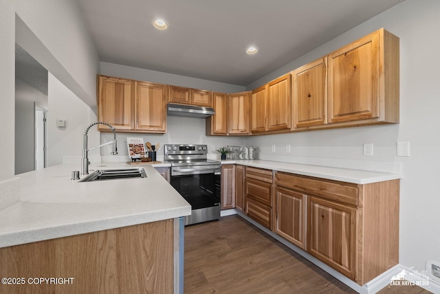 2105 W 47th Ave, Anchorage, AK 99517 - kitchen featuring stainless steel electric stove, under cabinet range hood, light countertops, dark wood-style flooring, and recessed lighting