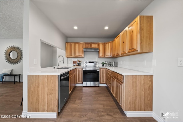 2105 W 47th Ave, Anchorage, AK 99517 - kitchen with appliances with stainless steel finishes, under cabinet range hood, dark wood-type flooring, light countertops, and recessed lighting