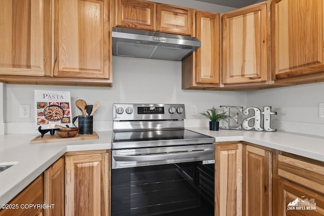 2105 W 47th Ave, Anchorage, AK 99517 - kitchen featuring stainless steel electric stove, exhaust hood, and light countertops