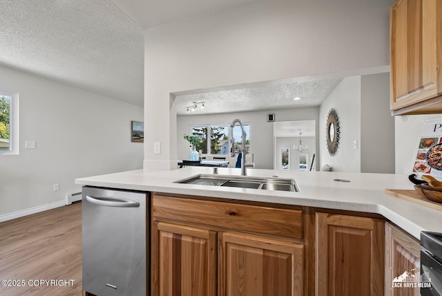 2105 W 47th Ave, Anchorage, AK 99517 - kitchen featuring a textured ceiling, dishwasher, light countertops, a baseboard heating unit, and light wood finished floors