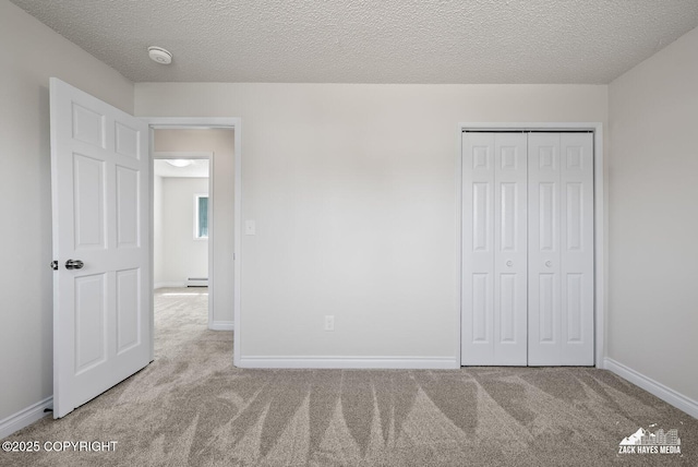 2105 W 47th Ave, Anchorage, AK 99517 - unfurnished bedroom with carpet floors, a baseboard radiator, a textured ceiling, and a closet