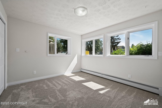 2105 W 47th Ave, Anchorage, AK 99517 - carpeted spare room with baseboard heating and a textured ceiling