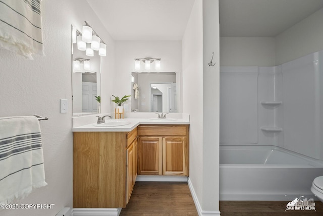 2105 W 47th Ave, Anchorage, AK 99517 - full bathroom featuring double vanity, wood finished floors, and bathtub / shower combination