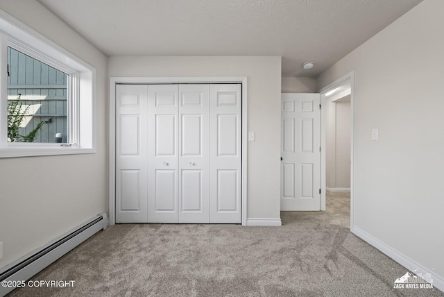 2105 W 47th Ave, Anchorage, AK 99517 - unfurnished bedroom with a baseboard radiator, carpet, and a closet