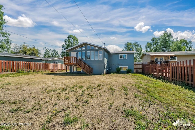 2105 W 47th Ave, Anchorage, AK 99517 - rear view of property featuring a fenced backyard and stairs