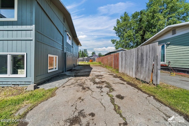 2105 W 47th Ave, Anchorage, AK 99517 - view of home's exterior featuring asphalt driveway and board and batten siding