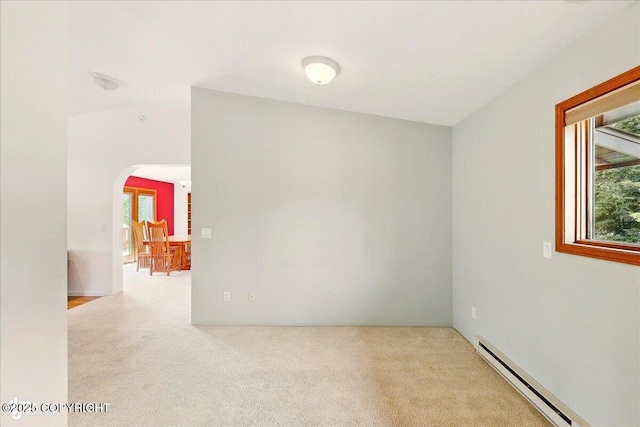 4085 Calhoun St, Homer, AK 99603 - spare room featuring a baseboard radiator, carpet flooring, and arched walkways
