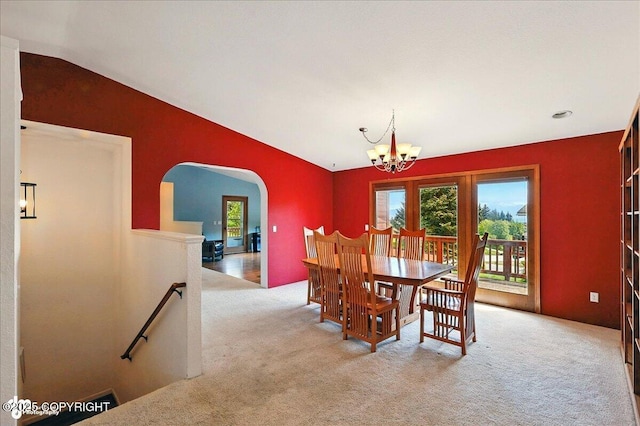 4085 Calhoun St, Homer, AK 99603 - carpeted dining space featuring arched walkways, healthy amount of natural light, a chandelier, and vaulted ceiling