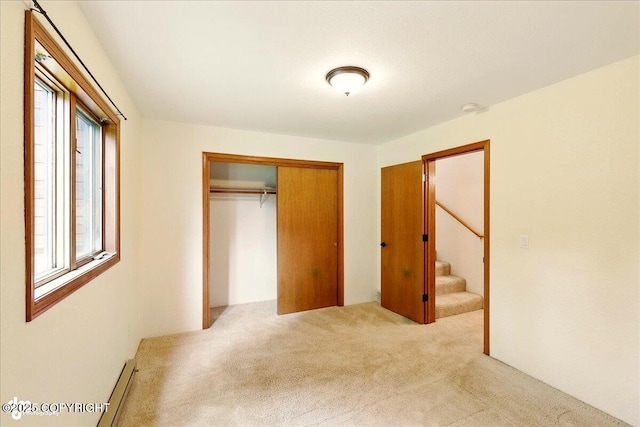 4085 Calhoun St, Homer, AK 99603 - unfurnished bedroom with carpet floors, a closet, and a baseboard radiator