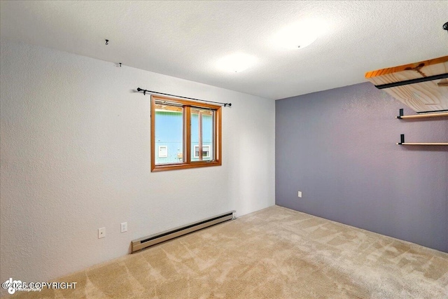 4085 Calhoun St, Homer, AK 99603 - empty room featuring a baseboard radiator, carpet, and a textured wall