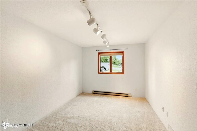 4085 Calhoun St, Homer, AK 99603 - carpeted spare room with a baseboard radiator and rail lighting