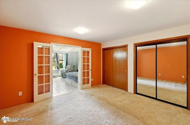 4085 Calhoun St, Homer, AK 99603 - unfurnished bedroom with french doors, carpet flooring, multiple closets, and baseboard heating