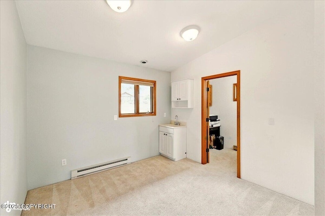 4085 Calhoun St, Homer, AK 99603 - unfurnished bedroom with a baseboard heating unit, light colored carpet, and a sink