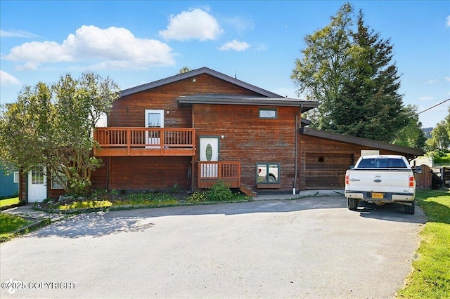 4085 Calhoun St, Homer, AK 99603 - view of front facade featuring asphalt driveway and a garage