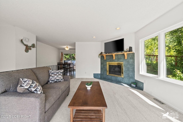 20213 David Ave, Eagle River, AK 99577 - living room featuring carpet flooring, a tiled fireplace, and recessed lighting
