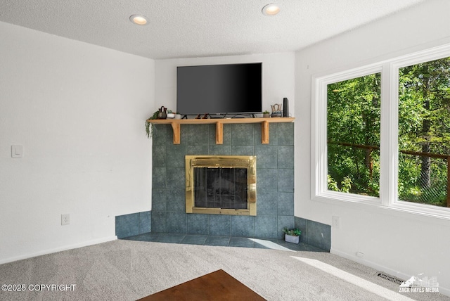 20213 David Ave, Eagle River, AK 99577 - unfurnished living room featuring carpet floors, healthy amount of natural light, a fireplace, a textured ceiling, and recessed lighting