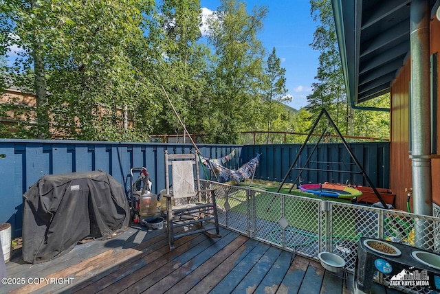 20213 David Ave, Eagle River, AK 99577 - wooden terrace featuring a playground, a grill, and a fenced backyard