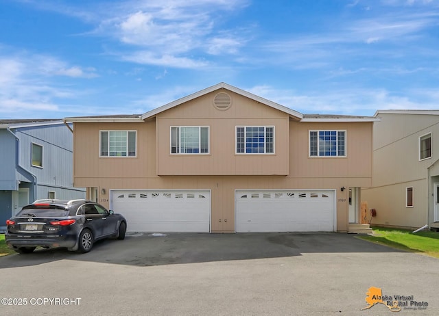 2922 Summer Sun Ct # 154, Anchorage, AK 99507 - townhome / multi-family property featuring an attached garage and driveway
