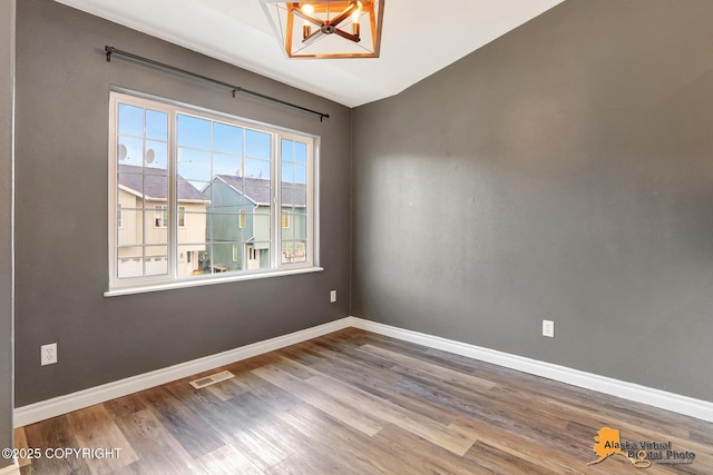 2922 Summer Sun Ct # 154, Anchorage, AK 99507 - spare room featuring wood finished floors and vaulted ceiling