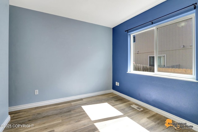 2922 Summer Sun Ct # 154, Anchorage, AK 99507 - spare room with wood finished floors and baseboards