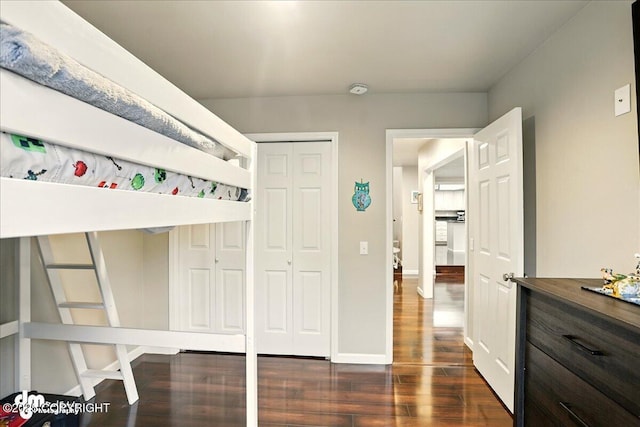 12830 Mission Cir, Anchorage, AK 99516 - bedroom with dark wood-style floors, a closet, and baseboards