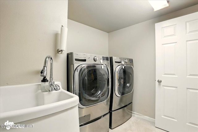 12830 Mission Cir, Anchorage, AK 99516 - laundry room with washer and dryer and baseboards