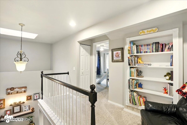 12830 Mission Cir, Anchorage, AK 99516 - hallway featuring carpet, a skylight, an upstairs landing, and baseboards