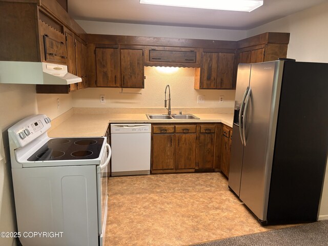 810 E 79th Ave, Anchorage, AK 99518 - kitchen with white appliances, under cabinet range hood, light flooring, and light countertops