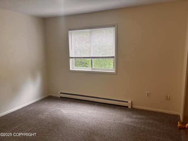 810 E 79th Ave, Anchorage, AK 99518 - unfurnished room with a baseboard heating unit and carpet