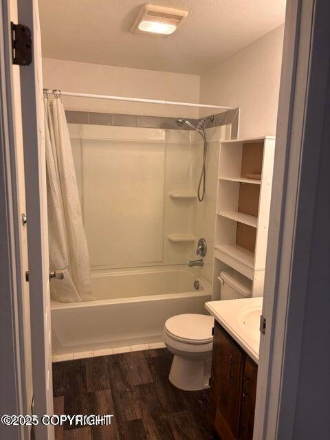 810 E 79th Ave, Anchorage, AK 99518 - full bathroom featuring shower / bath combo with shower curtain, vanity, and wood finished floors