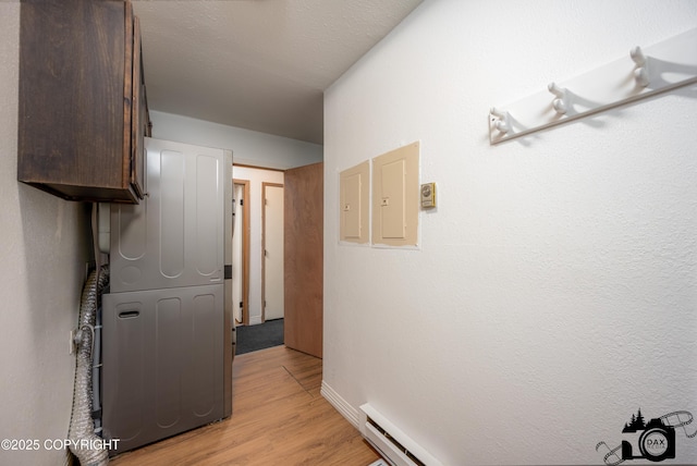 5275 E Birch Dr, Wasilla, AK 99654 - hall with light wood finished floors and stacked washer / dryer