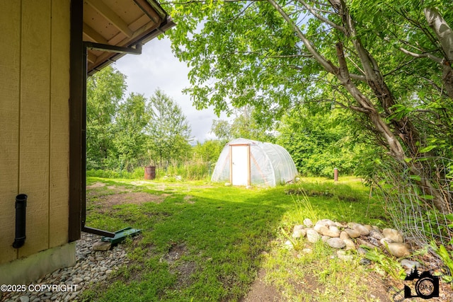 5275 E Birch Dr, Wasilla, AK 99654 - view of yard with a greenhouse and an outbuilding