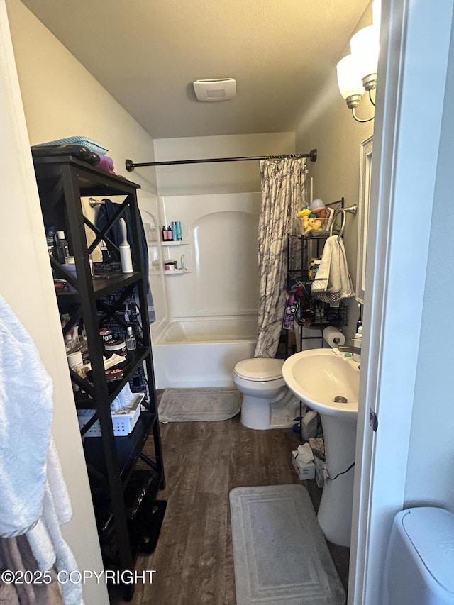 9074 W John St, Wasilla, AK 99654 - bathroom with shower / bathtub combination with curtain and wood finished floors