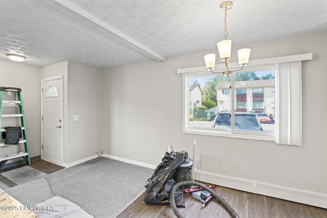 1100 Fred Cir, Anchorage, AK 99515 - dining room featuring a baseboard heating unit, a chandelier, baseboards, a textured ceiling, and wood finished floors