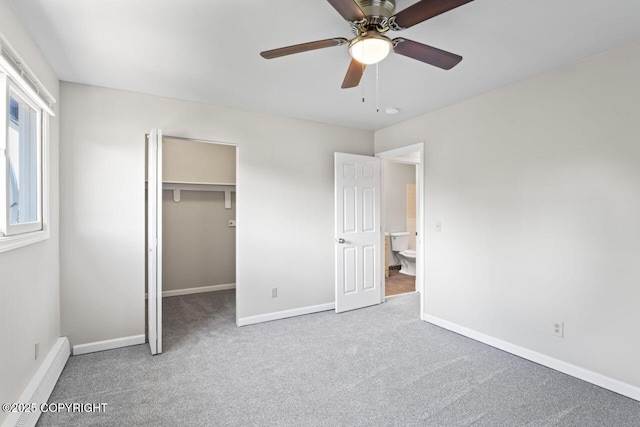 1100 Fred Cir, Anchorage, AK 99515 - unfurnished bedroom featuring baseboard heating, carpet flooring, a spacious closet, and baseboards