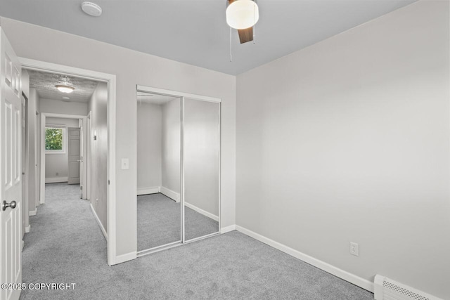 1100 Fred Cir, Anchorage, AK 99515 - unfurnished bedroom featuring carpet floors, a baseboard heating unit, baseboards, a closet, and ceiling fan